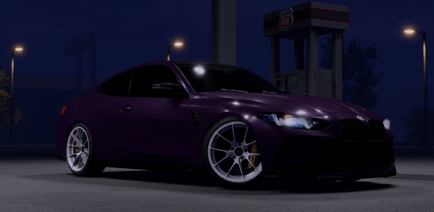 Purple BMW coupe at a night time service station